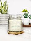 Comfort is a soy wax candle made of lavender woods and honey. This is a relaxing scent made with cotton wicks on a wooden coaster. 